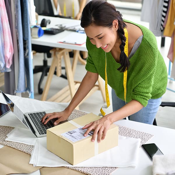 Small business ecommerce owner looking up tracking number on computer