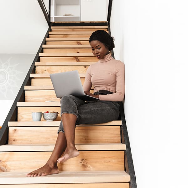 Woman looking at laptop learning about The 3 Types of SEO