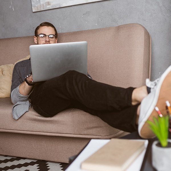 Man on his computer reading an article on why you should invest in blogging for your business
