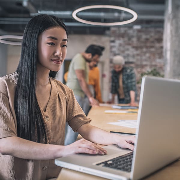 Woman at computer reading about SEO Managed Services