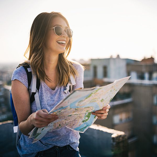 Woman tourist looking at map in the city