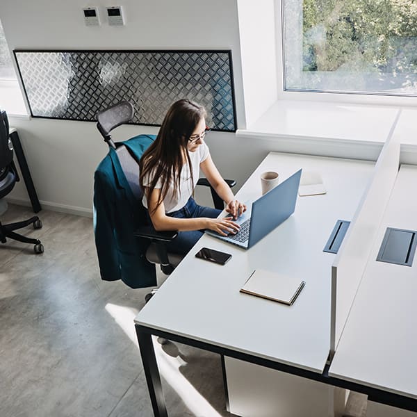 Woman at Laptop reading 9 Tips to Find the Best WordPress Development Company
