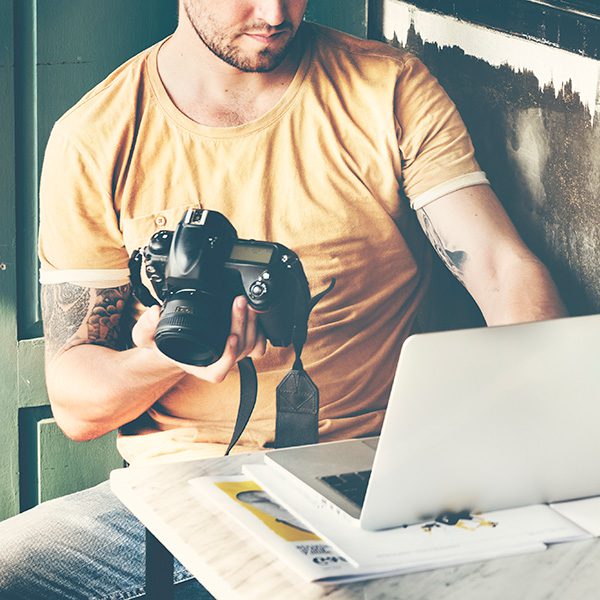 Man looking at laptop learning about stock photos