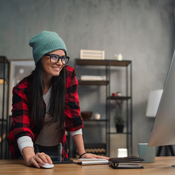 Woman on her computer uploading a video to Google Drive