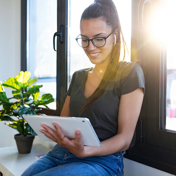 Realtor on her tablet reading about real estate social media marketing