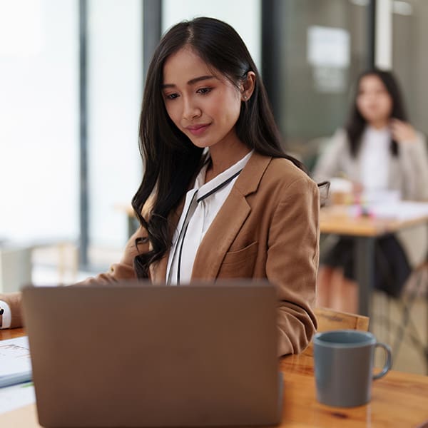 The Benefits of Hiring a Digital Marketing Consultant 2 Woman on her laptop searching for a digital marketing consultant