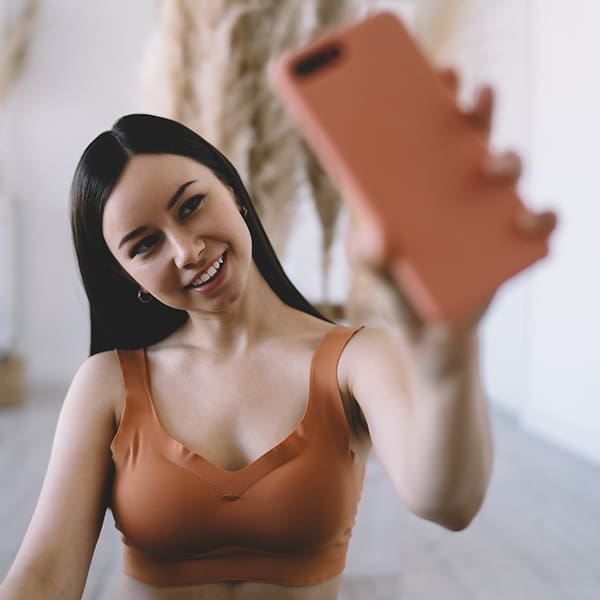 Woman on her phone making a video about social media video production