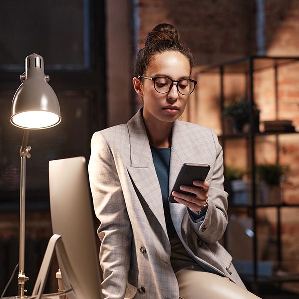 Woman on her phone learning about LinkedIn SEO