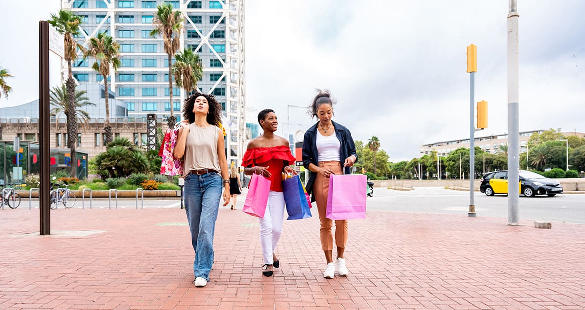 Retail Digital Marketing: Connecting with Your Customers 7 Three women retail shopping walking down a brick sidewalk