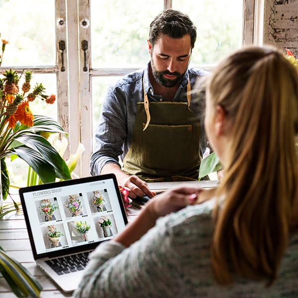 Business owners at their store learning about Shopify SEO