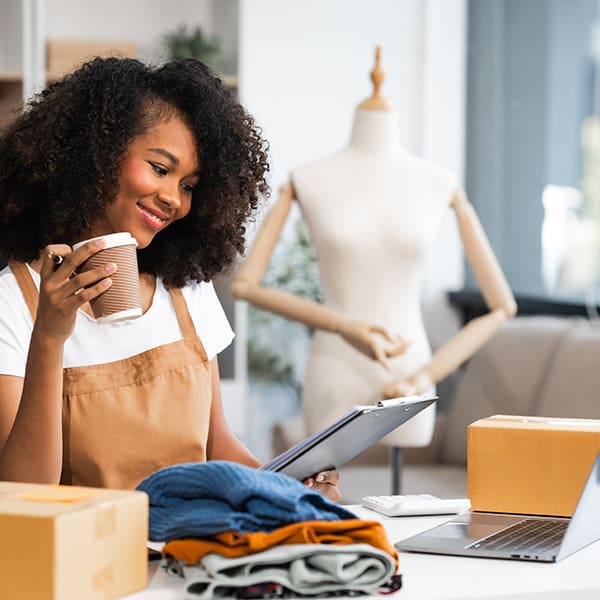 Woman on her computer seeing the benefits of web hosting for ecommerce